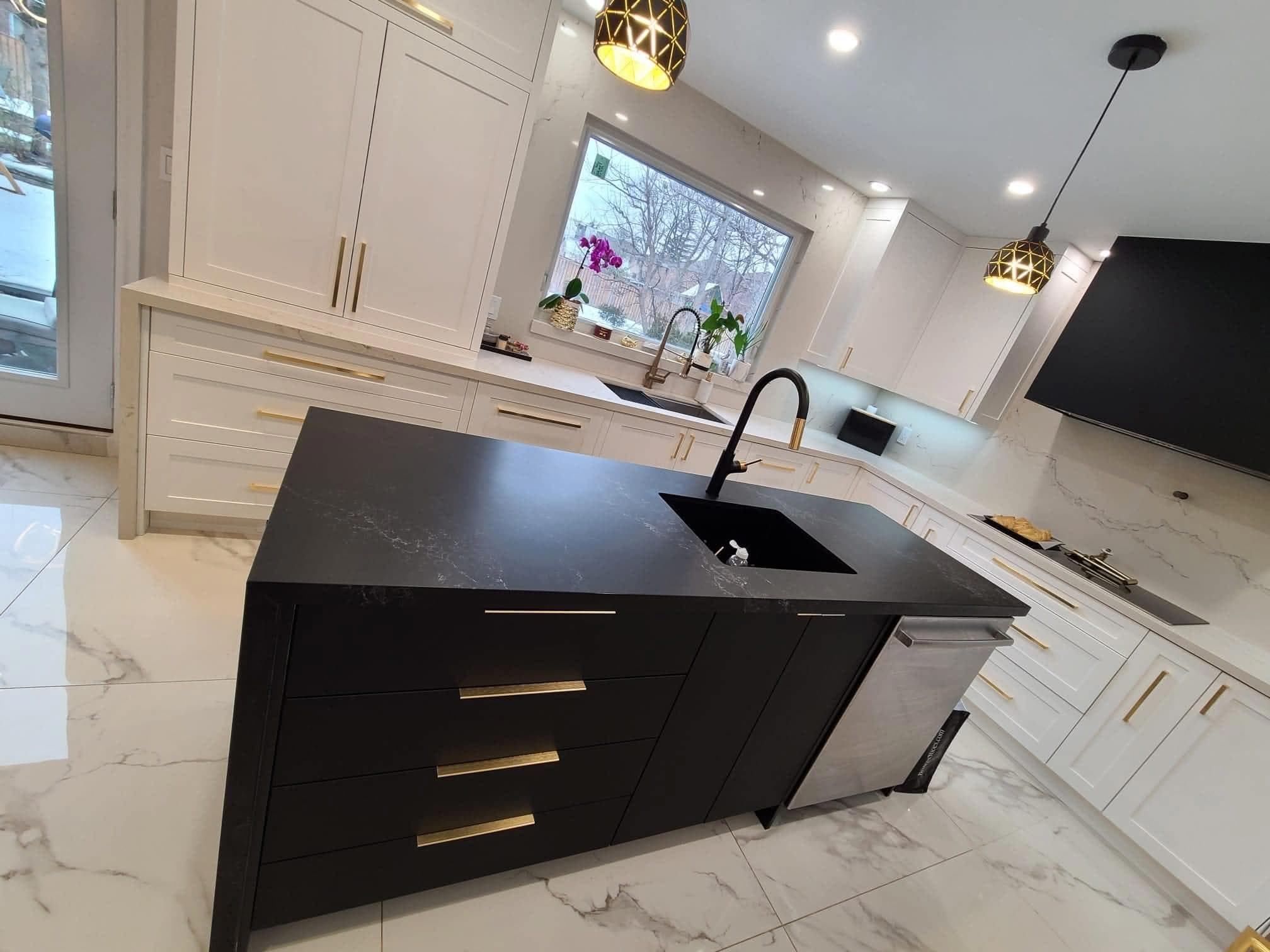 Custom black kitchen island with gold hardware and pendant lighting, completed by Diamond Hammer Construction in Vaughan